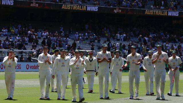 Australian players celebrate their win over England on the third day of their cricket test match in Melbourne, Australia, Tuesday, Dec. 28, 2021. Australia wins the test by an innings and 14 runs and has retained the Ashes. (AP Photo/Asanka Brendon Ratnayake)