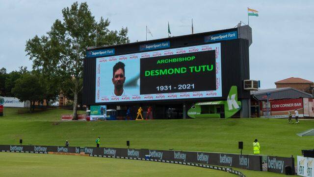 An electronic screen showing South Africa's Keshav Maharaj, wit teammates line up for minute's silence in the memory of Desmond Tutu ahead of their Test Cricket match between South Africa India at Centurion Park in Pretoria, South Africa, Sunday, Dec. 26, 2021. (AP Photo/Themba Hadebe)