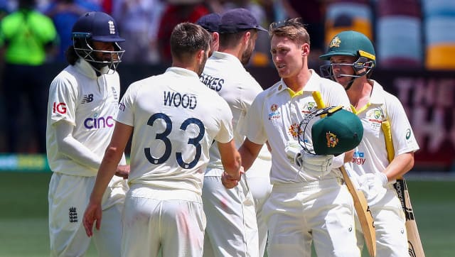 Marnus Labuschagne and Marcus Harris shake hands with the English players after guiding Australia to a nine-wicket win in the first Ashes Test in Brisbane. AP