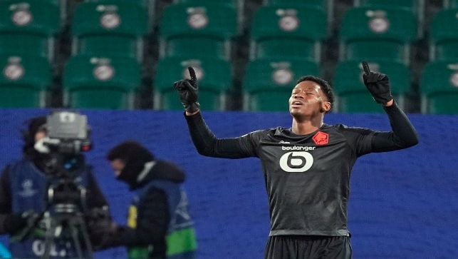 Lille’s Jonathan David celebrates after scoring his side’s second goal during the Champions League group G match between VfL Wolfsburg and Lille OSC in Wolfsburg, Germany, on Wednesday. AP