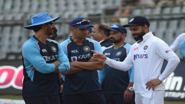 Virat Kohli interacts with coach Rahul Dravid at the end of the fourth day of the second Test match between India and New Zealand at the Wankhede Stadium in Mumbai on Monday. AFP