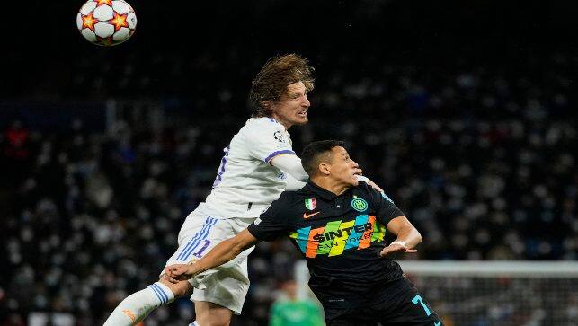 Real Madrid's Luka Modric, top, goes for a header with Inter Milan's Alexis Sanchez during the Champions League group D soccer match at the Santiago Bernabeu stadium, in Madrid, Spain, on Tuesday. AP 