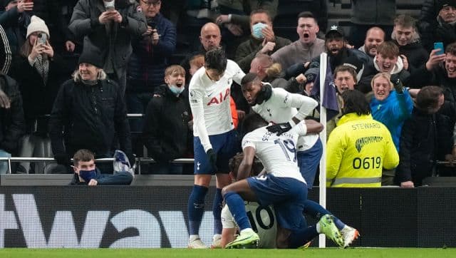 Tottenham's Harry Kane celebrates with teammates after scoring his side's opening goal during the English Premier League soccer match between Tottenham Hotspur and Liverpool at the Tottenham Hotspur Stadium in London, Sunday, Dec. 19, 2021. (AP Photo/Frank Augstein)