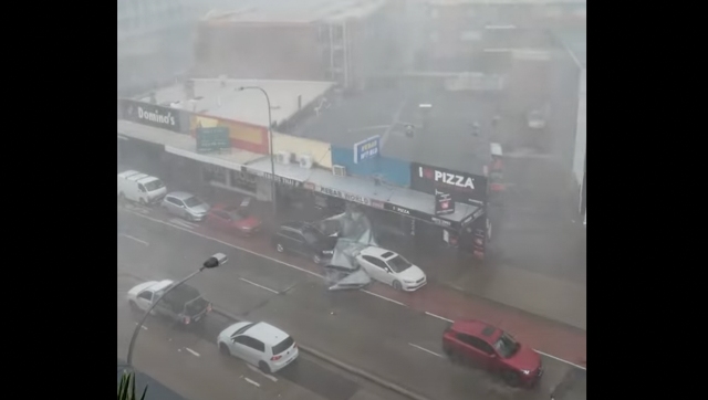 Australia: Metal roof crashes between cars during storm, watch viral video here Australia: Metal roof crashes between cars during storm, watch viral video here