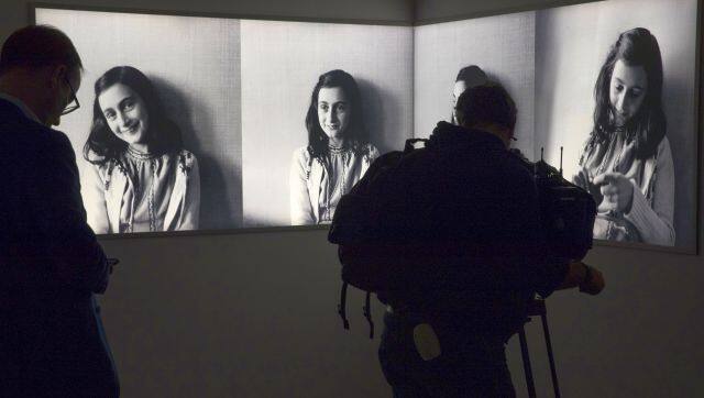 File image of a journalist taking images of pictures of Anne Frank at the renovated Anne Frank House Museum in Amsterdam. AP