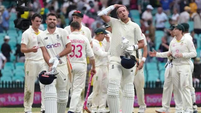 England's not out batsmen James Anderson, left, and Stuart Broad walk off at a the end of their Ashes cricket test match against Australia in Sydney, Sunday, Jan. 9, 2022. The Match ends in a draw. (AP Photo/Rick Rycroft)