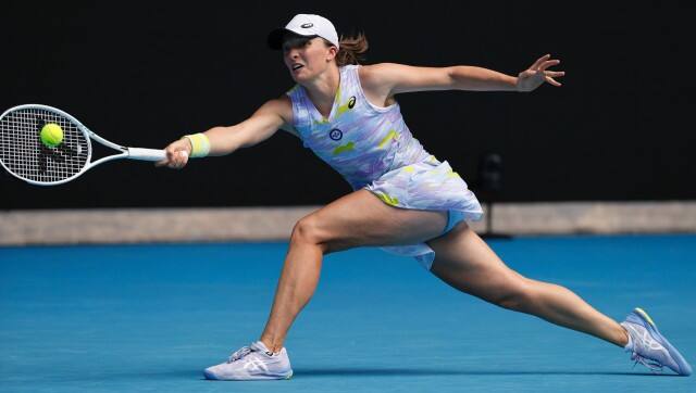 Iga Swiatek of Poland plays a forehand return to Kaia Kanepi of Estonia during their quarterfinal match at the Australian Open tennis championships in Melbourne, Australia, Wednesday, Jan. 26, 2022. (AP Photo/Tertius Pickard)