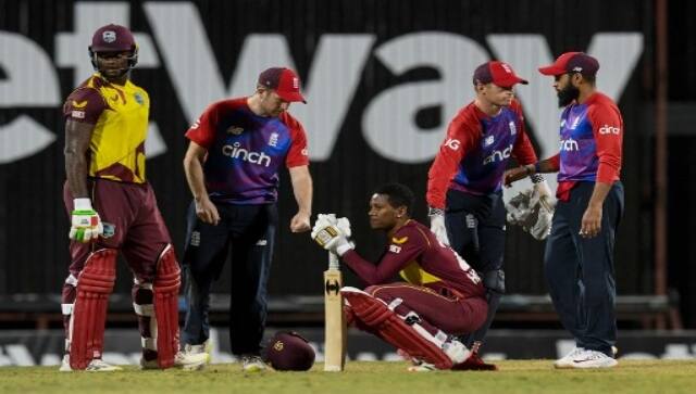 Liam Dawson (2L), Sam Billings (2R) and Adil Rashid (R) of England console Akeal Hosein (C) and Romario Shepherd (L) of West Indies while they express disappointment after losing the 2nd T20I between West Indies and England at Kensington Oval, Bridgetown, Barbados, on January 23, 2022. AFP