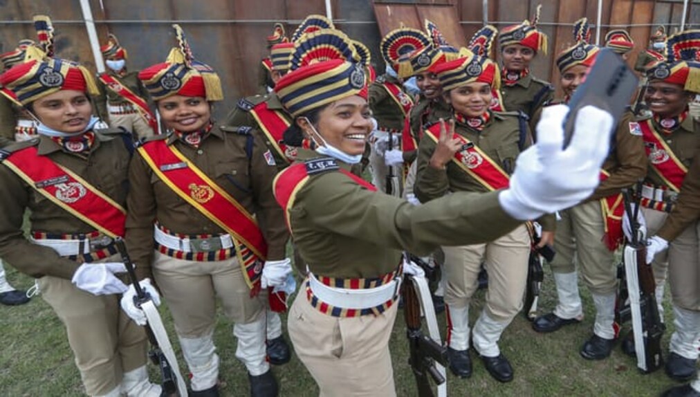 Indian Railway Protection Force personnel take selfies before marching during Republic Day celebrations in Hyderabad. As per a report by <em>AP</em>, media reports said the country had planned to invite leaders of five Central Asian countries — including Turkmenistan, Kazakhstan, Uzbekistan, Tajikistan and Kyrgyzstan — as guests at the Republic Day parade, but cancelled the plan due to the pandemic. Image Courtesy: AP