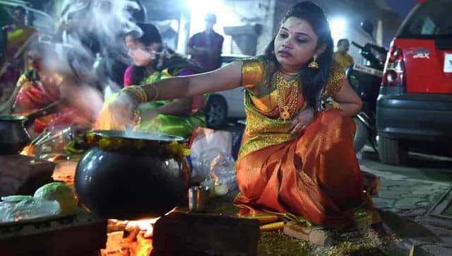 A devotee cooks sweet dishes on the occasion of Pongal festival. PTI