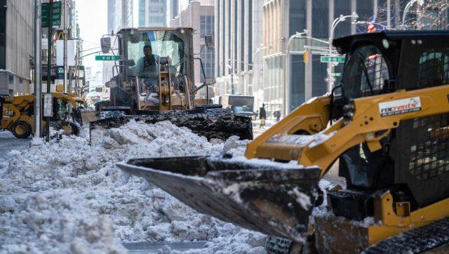 Workers plow snow on 6th Avenue after a blizzard hit the Northeast in New York City. AFP