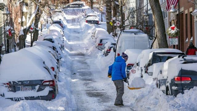A person shovels snow in Boston, Massachusetts. Blinding snow whipped up by powerful winds pummelled the eastern United States. AFP