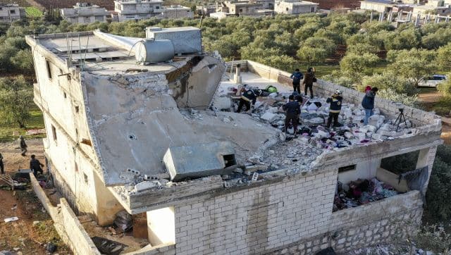 People inspect a destroyed house following an operation by the US military in the Syrian village of Atmeh, in Idlib province, Syria. AP