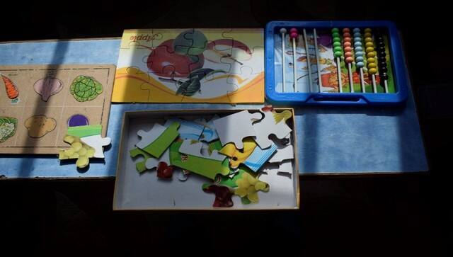 At Kamran’s home, puzzles and therapy lie on a shelf. His parents say, he barely uses them after his school closed 