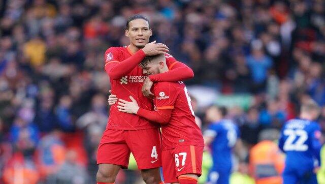 Liverpool's Harvey Elliott is embraced by Liverpool's Virgil van Dijk after the FA Cup fourth round soccer match between Liverpool and Cardiff City at Anfield stadium in Liverpool, England, on Sunday. AP