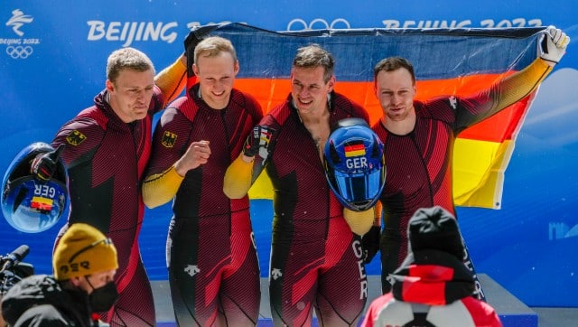 Francesco Friedrich, Thorsten Margis, Candy Bauer and Alexander Schueller, of Germany, celebrate winning the gold medal in the 4-man at the 2022 Winter Olympics, Sunday, Feb. 20, 2022, in the Yanqing district of Beijing. (AP Photo/Mark Schiefelbein)