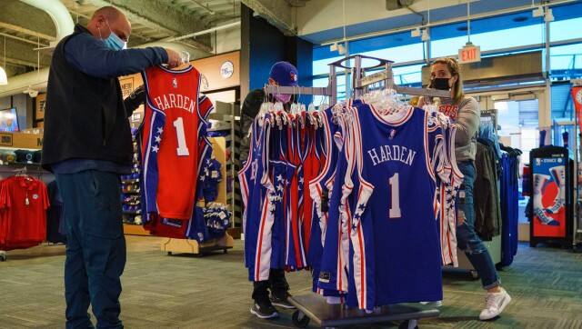 Fans look over the jerseys of newly acquired Philadelphia 76ers' James Harden before the team's NBA basketball game against the Oklahoma City Thunder, Friday, Feb. 11, 2022, in Philadelphia. Harden will not play for the Sixers in games Friday and Saturday night, and he won't play until he's evaluated this weekend by the team's performance staff. The earliest Harden could play for Philly is at home Tuesday against Boston. The Sixers also play Thursday at NBA champion Milwaukee before the All-Star break. (AP Photo/Chris Szagola)