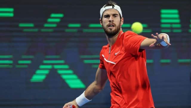 Karen Khachanov of Russia returns the ball to Roberto Bautista Agut of Spain during the tennis semi-final match of the 2022 ATP Qatar Open in Doha on February 18, 2022. (Photo by KARIM JAAFAR / AFP)