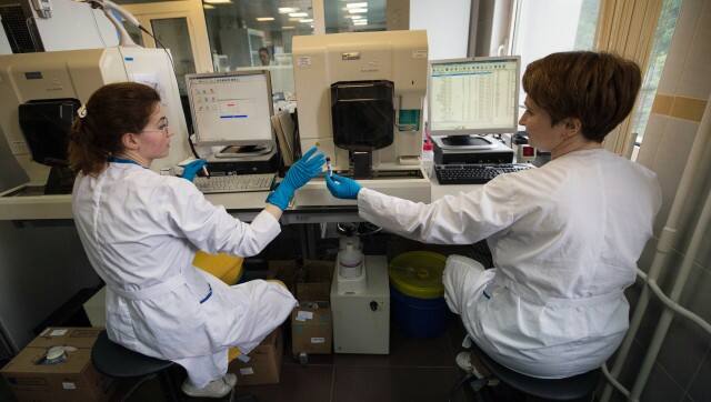 FILE - In this May 24, 2016 file photo employees work in Russia's national drug-testing laboratory in Moscow. For the Sochi Games in 2014, Russian medal contenders handed over samples of clean urine months in advance before taking a cocktail of steroids dissolved in alcohol, according to Grigory Rodchenkov, then the director of the drug-testing lab for the Games, who later fled to the United States. During the Olympics, Rodchenkov said he swapped out samples via a hole in the wall of the laboratory to a person from the Russian security services who opened the urine sample bottles and replaced the contents with the stored, clean urine. (AP Photo/Alexander Zemlianichenko, File)