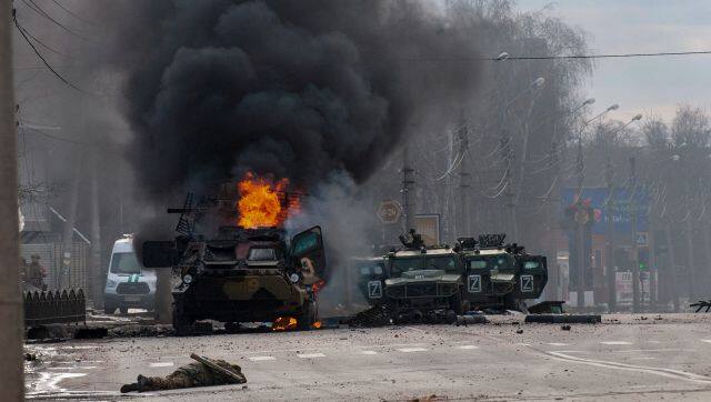 A Russian armored personnel carrier burns amid damaged and abandoned light utility vehicles after fighting in Kharkiv, Ukraine, Sunday, Feb. 27, 2022. The city authorities said that Ukrainian forces engaged in fighting with Russian troops that entered the country's second-largest city on Sunday. (AP Photo/Marienko Andrew)