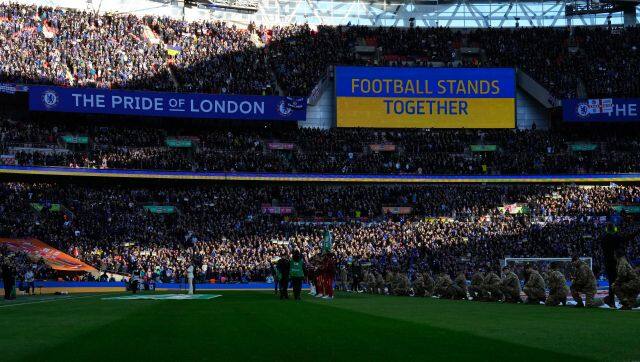 A video screen displays the Ukrainian flag, during the English League Cup final soccer match between Chelsea and Liverpool at Wembley stadium in London, Sunday, Feb. 27, 2022. (AP Photo/Alastair Grant)