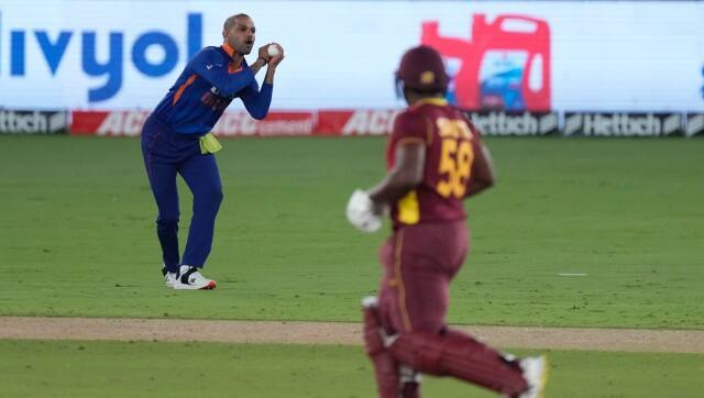 India's Shikhar Dhawan, left, takes the catch to dismiss West Indies' Odean Smith, right, during the third one day international cricket match between India and West Indies in Ahmedabad, India, Friday, Feb. 11, 2022. (AP Photo/Ajit Solanki)