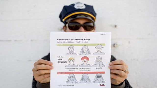 File image of a model holding up an information pamphlet about Austrian restrictions banning the wearing of burqas and other items covering the face in public places and buildings, in Vienna. AFP