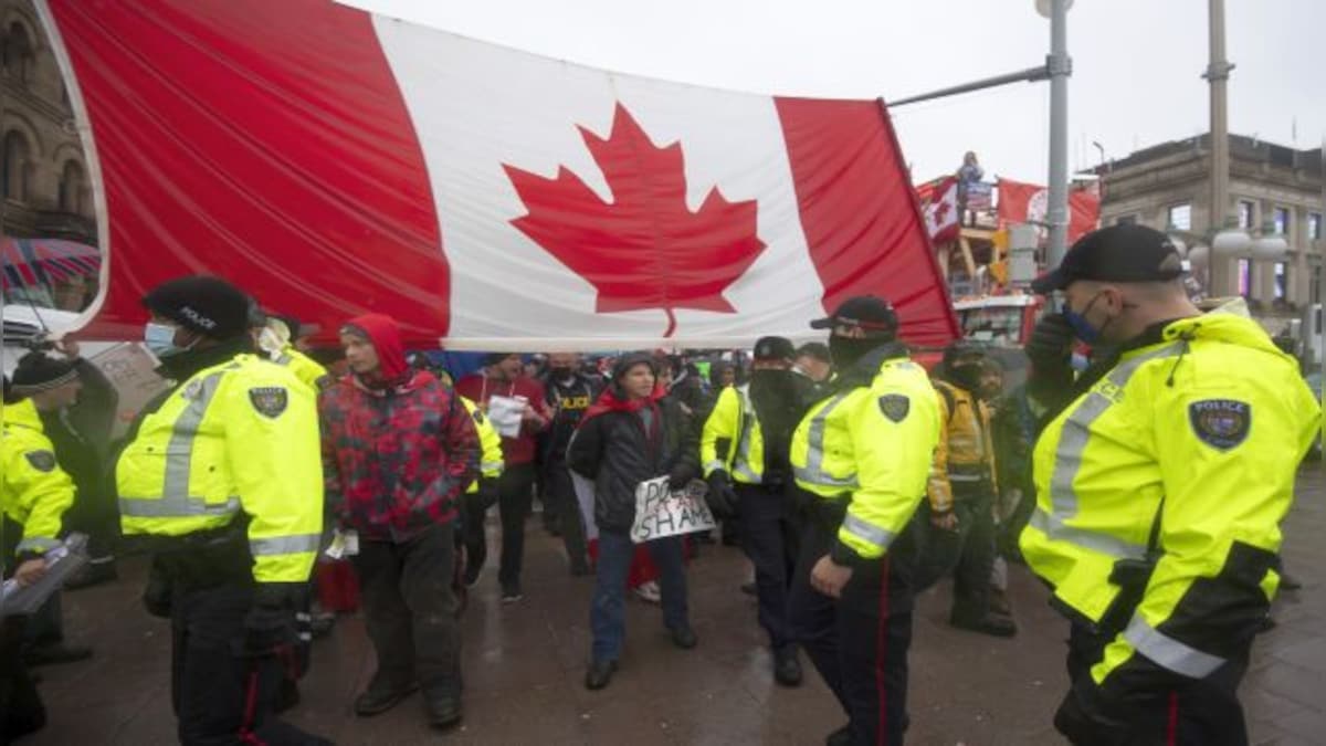 ‘There’s no tow trucks that can touch us’: Canada truckers hold their ground despite threats of police crackdown