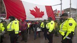 ‘There’s no tow trucks that can touch us’: Canada truckers hold their ground despite threats of police crackdown