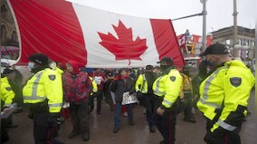 ‘There’s no tow trucks that can touch us’: Canada truckers hold their ground despite threats of police crackdown