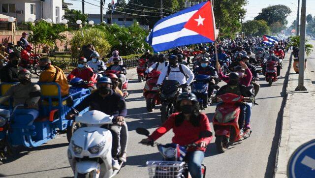 Motorcyclists with a Cuban flag take part in a caravan against the US embargo against Cuba in Santa Clara, Villa Clara province, Cuba. AFP