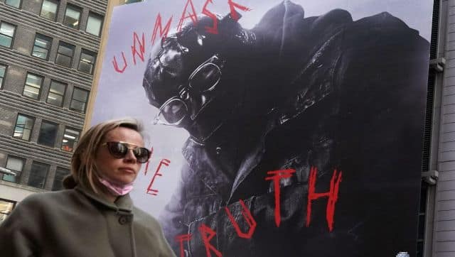 A woman passes by a ad for the movie 