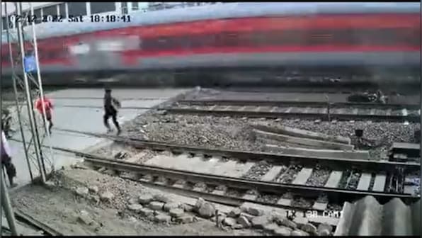 Caught on camera: Biker escapes moving train in the nick of time, motorcycle blown to smithereens