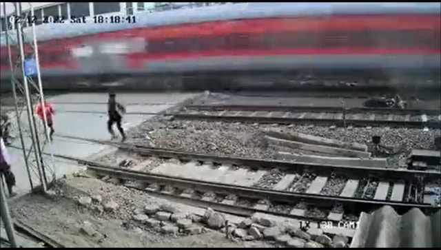 Caught on camera: Biker escapes moving train in the nick of time, motorcycle blown to smithereens Caught on camera: Biker escapes moving train in the nick of time, motorcycle blown to smithereens