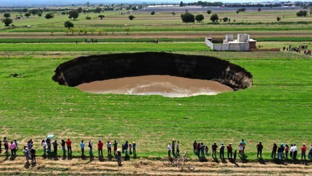 An aerial view of a sinkhole that was found by farmers in a field of crops in Santa Maria Zacatepec, state of Puebla, Mexico in May 2021. AFP