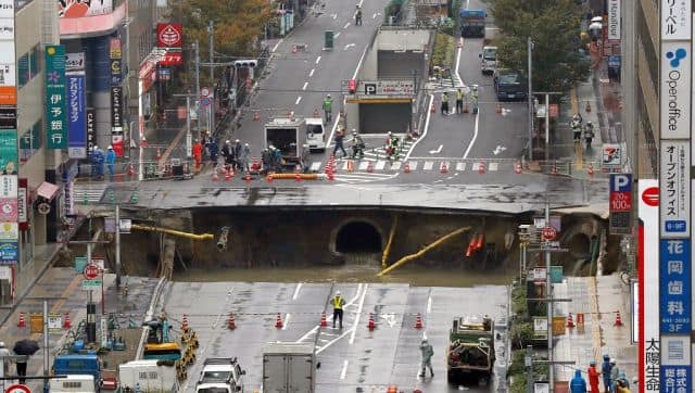 File image of a giant sinkhole in a five-lane urban boulevard, exposing support columns of nearby buildings at a traffic intersection in Fukuoka, southwestern Japan. AFP