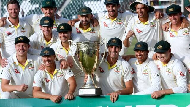 Australian players jubilate and pose for photograph with trophy after winning the third Test and series against Pakistan. AP