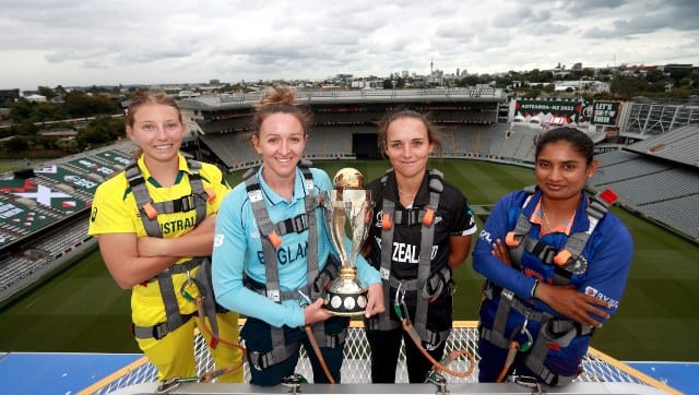 Australia seamer Darcie Brown, England seamer Kate Cross, New Zealand all-rounder Amelia Kerr and India captain and middle-order batter Mithali Raj pose with the World Cup atop the Eden Park roof. Image credit: Twitter/@cricketworldcup