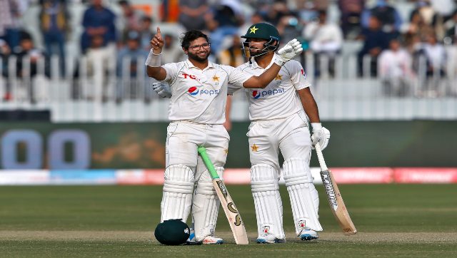 Pakistan’s Imam-ul-Haq, left, celebrates after completing century while teammate Abdullah Shafique watches during Day 5 of the first Test between Pakistan and Australia at the Pindi Stadium, in Rawalpindi, Pakistan, on Tuesday. AP