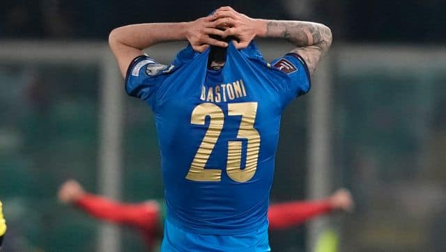 North Macedonia players celebrate as Italy's Alessandro Bastoni reacts after his team's got eliminated at the end of the World Cup qualifying play-off soccer match between Italy and North Macedonia, at Renzo Barbera stadium, in Palermo, Italy, Thursday, March 24, 2022. North Macedonia won 1-0. (AP Photo/Antonio Calanni)