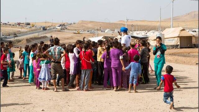 A Khalsa Aid volunteer with Syrian refugees. Image courtesy: Khalsa Aid International
