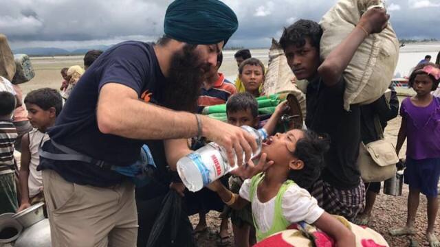 A Khalsa Aid volunteer offering water to a Rohingya child. Image courtesy: Khalsa Aid International