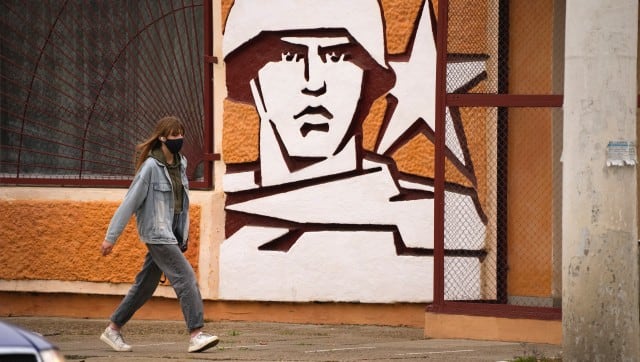 FILE - A woman walks past the Operational Group of Russian Forces headquarters in Tiraspol, the capital of the breakaway region of Transnistria, a disputed territory unrecognized by the international community, in Moldova, Nov. 1, 2021. For some European countries watching Russia's bloody invasion of Ukraine, there are fears that they could be next. Western officials say the most vulnerable could be those who are not members of the NATO military alliance or the European Union, and thus alone and unprotected — including Ukraine’s neighbor Moldova and Russia's neighbor Georgia, both of them formerly part of the Soviet Union — along with the Balkan states of Bosnia and Kosovo. (AP Photo/Dmitri Lovetsky, File)