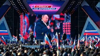 Vladimir Putin appears at a huge flag-waving rally in Moscow as Russian troops continue to rain fire in Ukraine