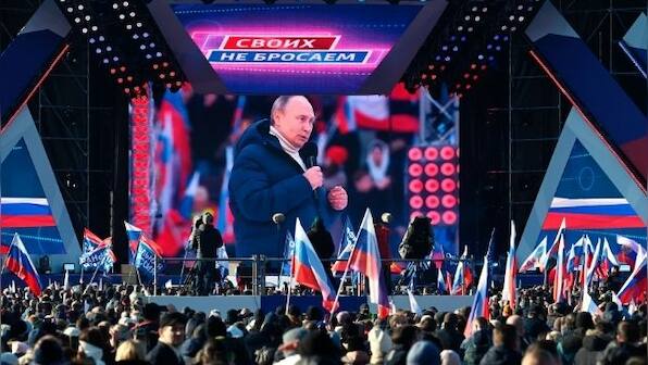 Vladimir Putin appears at a huge flag-waving rally in Moscow as Russian troops continue to rain fire in Ukraine