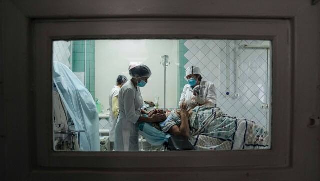 Medical workers show a newborn baby to a woman who gave birth at the maternity hospital converted into a medical ward in Mariupol, Ukraine, Tuesday, March 1, 2022. Russian strikes on the key southern port city of Mariupol seriously wounded several people. (AP Photo/Evgeniy Maloletka)