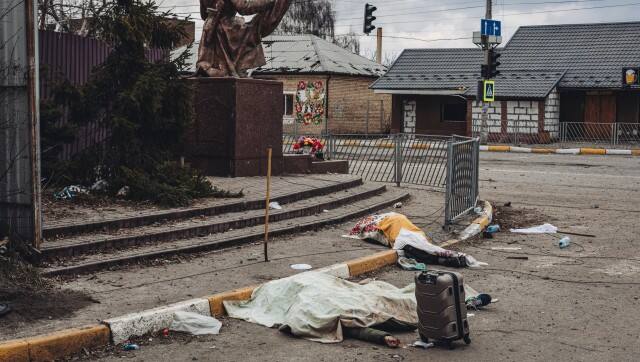 The dead bodies of people killed by Russian shelling lay covered in the street in the town of Irpin, Ukraine, Sunday, March 6, 2022. With the Kremlin's rhetoric growing fiercer and a reprieve from fighting dissolving, Russian troops continued to shell encircled cities and the number of Ukrainians forced from their country grew to over 1.4 million. (AP Photo/Diego Herrera Carcedo)