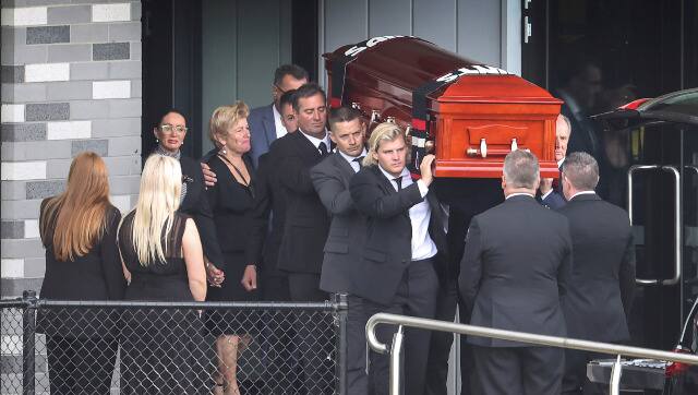 Shane Warne Funeral St Kilda Football Ball Club Moorabbin. The coffin of Shane Warne is carried out by his son Jackson. Picture: David Caird