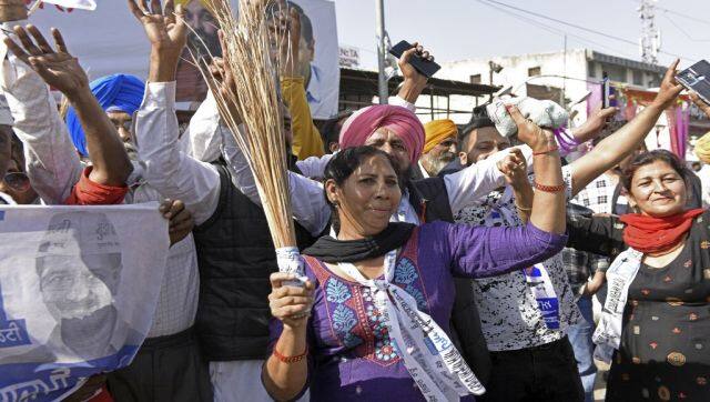 Supporters of AAP celebrate after their party's win in the Punjab state Assembly elections in Amritsar. AFP