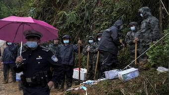 China plane crash: Searchers find wing and engine parts from site of tragedy